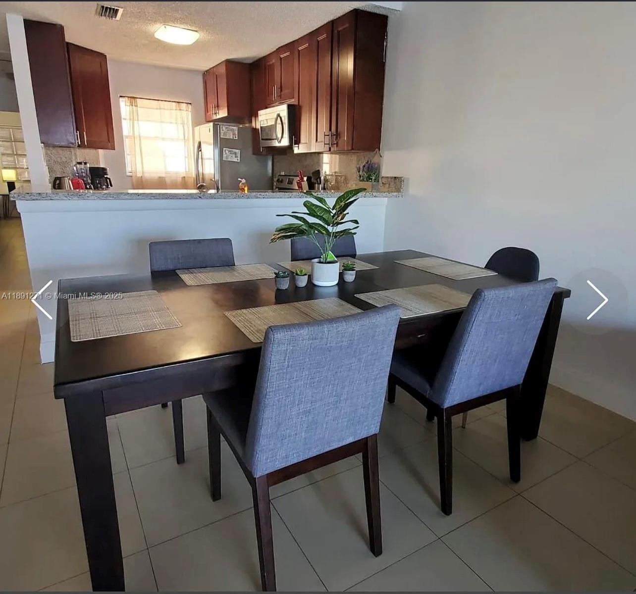 2421 Southwest 58th Manor, Unit 1 Dania Beach, FL 33312 - Photo 10 of 15 a view of a dining room with furniture