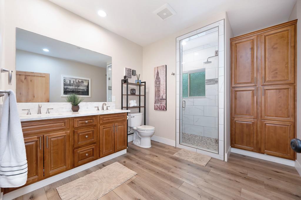 3960 Fort Jim Road Placerville, CA 95667 - Photo 40 of 64 a spacious bathroom with a double vanity sink a large mirror and a shower