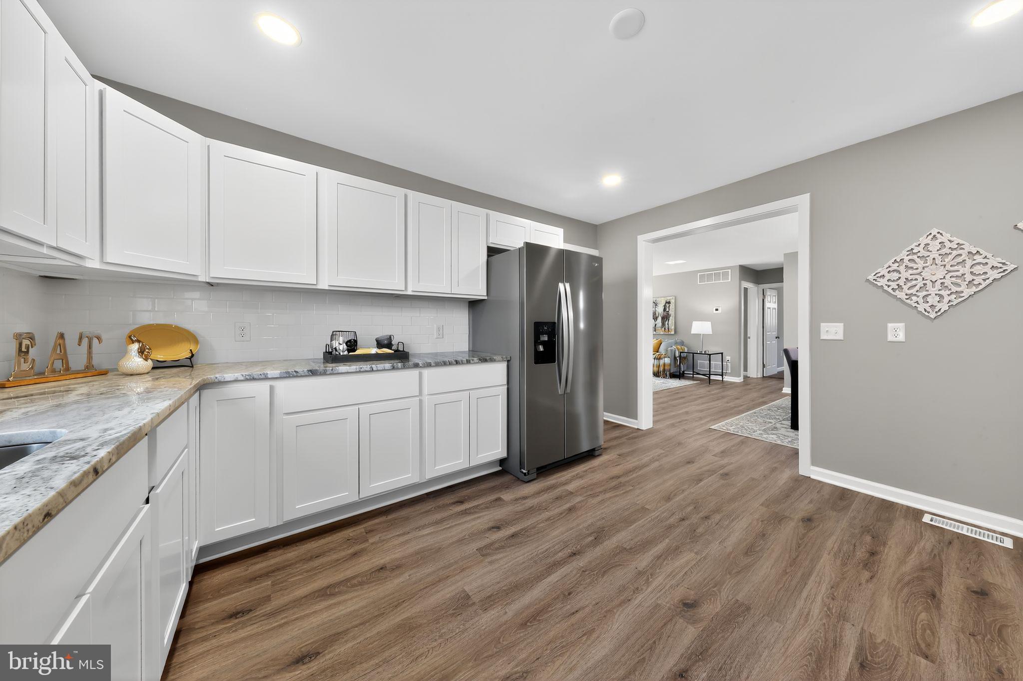 261 West Main Street Elkton, MD 21921 - Photo 18 of 31 a kitchen with granite countertop white cabinets and refrigerator