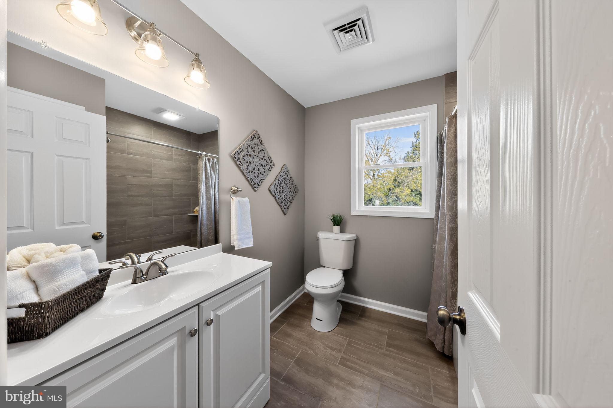 261 West Main Street Elkton, MD 21921 - Photo 5 of 31 a bathroom with a sink a toilet and shower