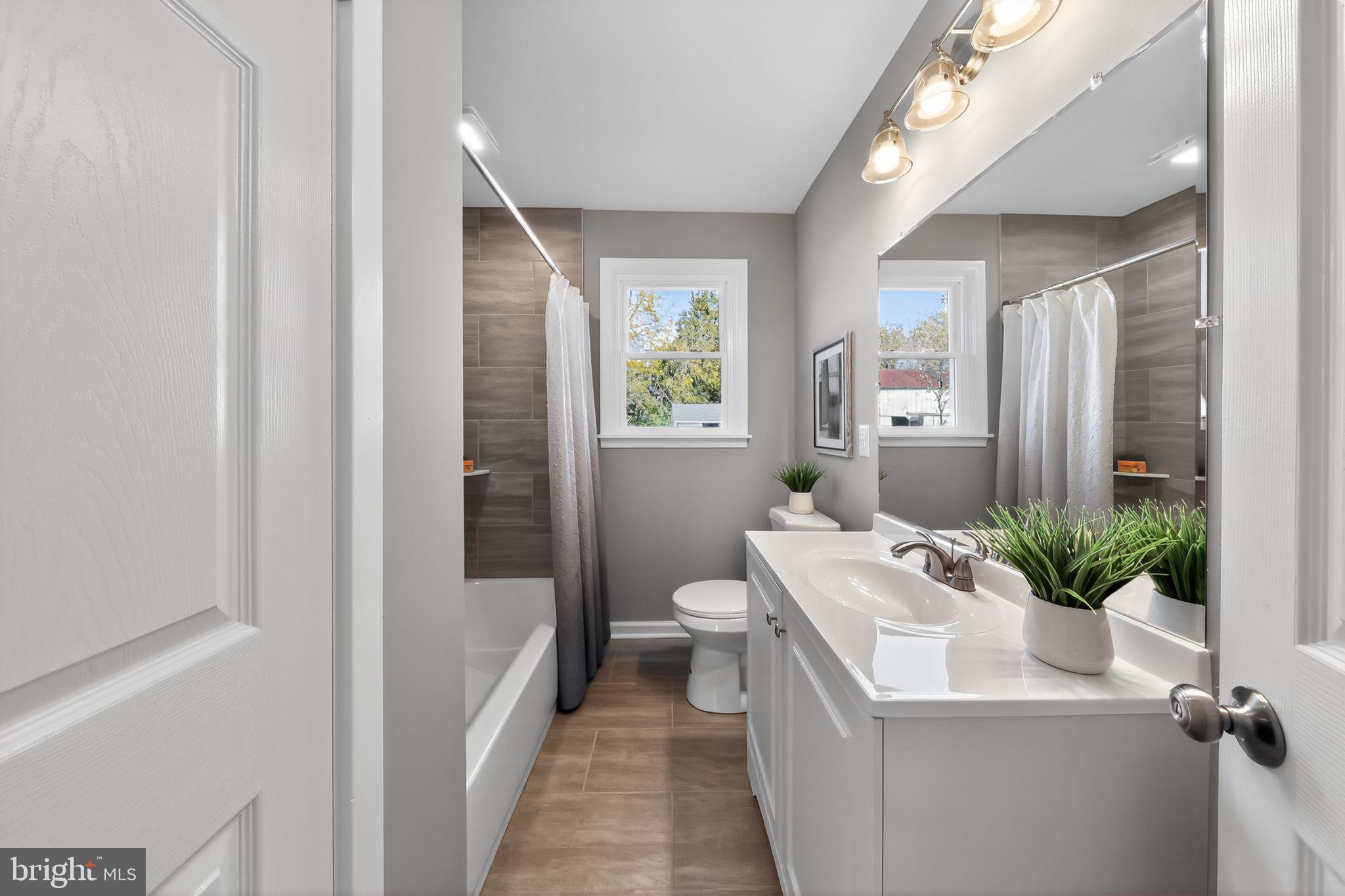 261 West Main Street Elkton, MD 21921 - Photo 7 of 31 a bathroom with a sink a toilet and shower