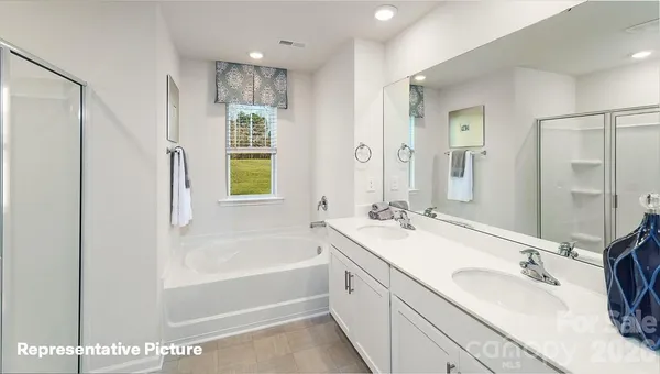 a bathroom with a shower and a glass door