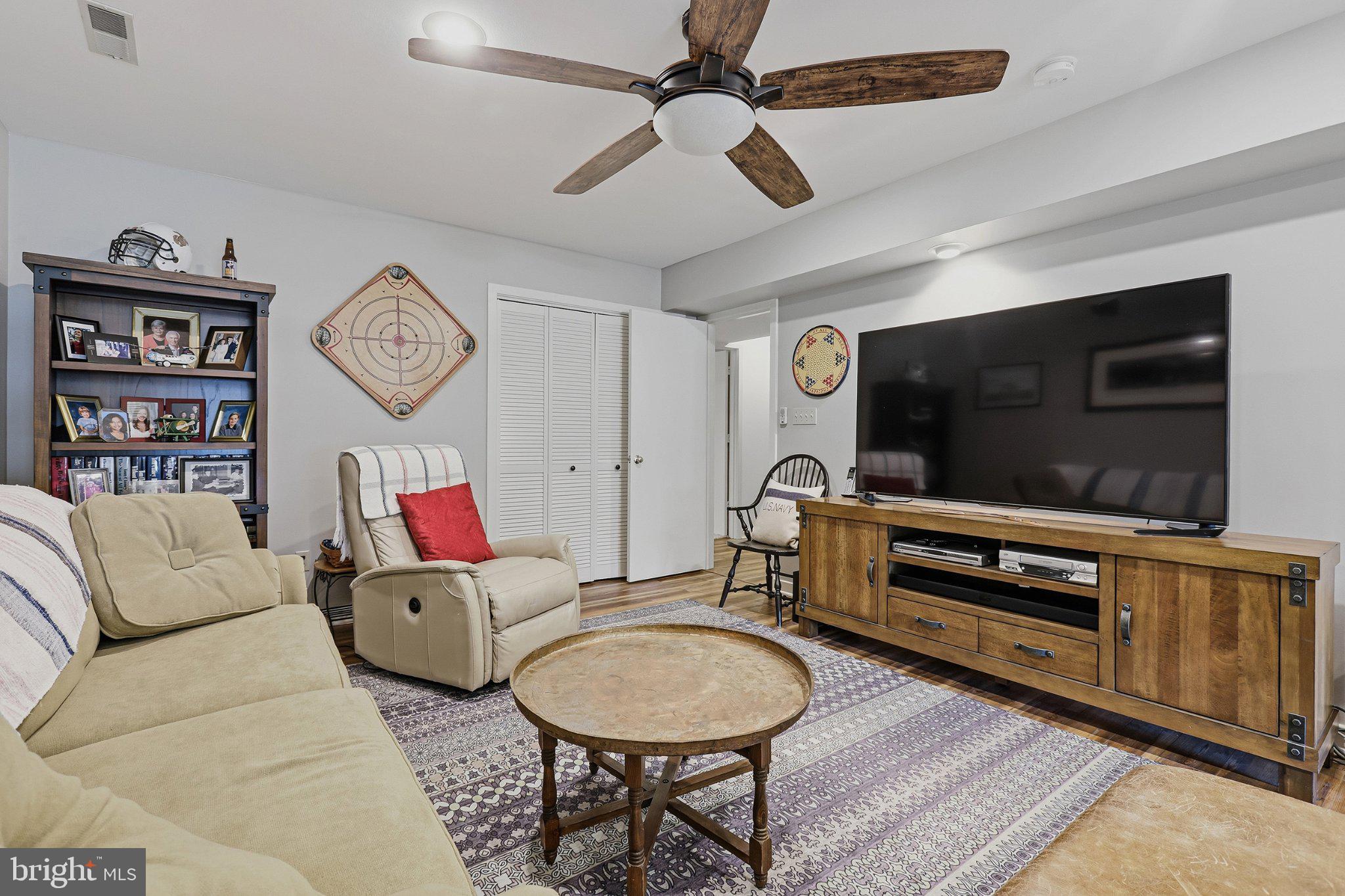6495 Tides Road King George, VA 22485 - Photo 30 of 65 a living room with furniture and a flat screen tv