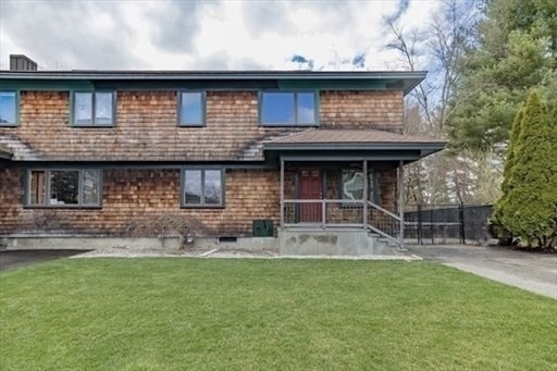 39 Neillian Street, Unit 39 Bedford, MA 01730 - Photo 1 of 29 a brick house with a small yard in front of it