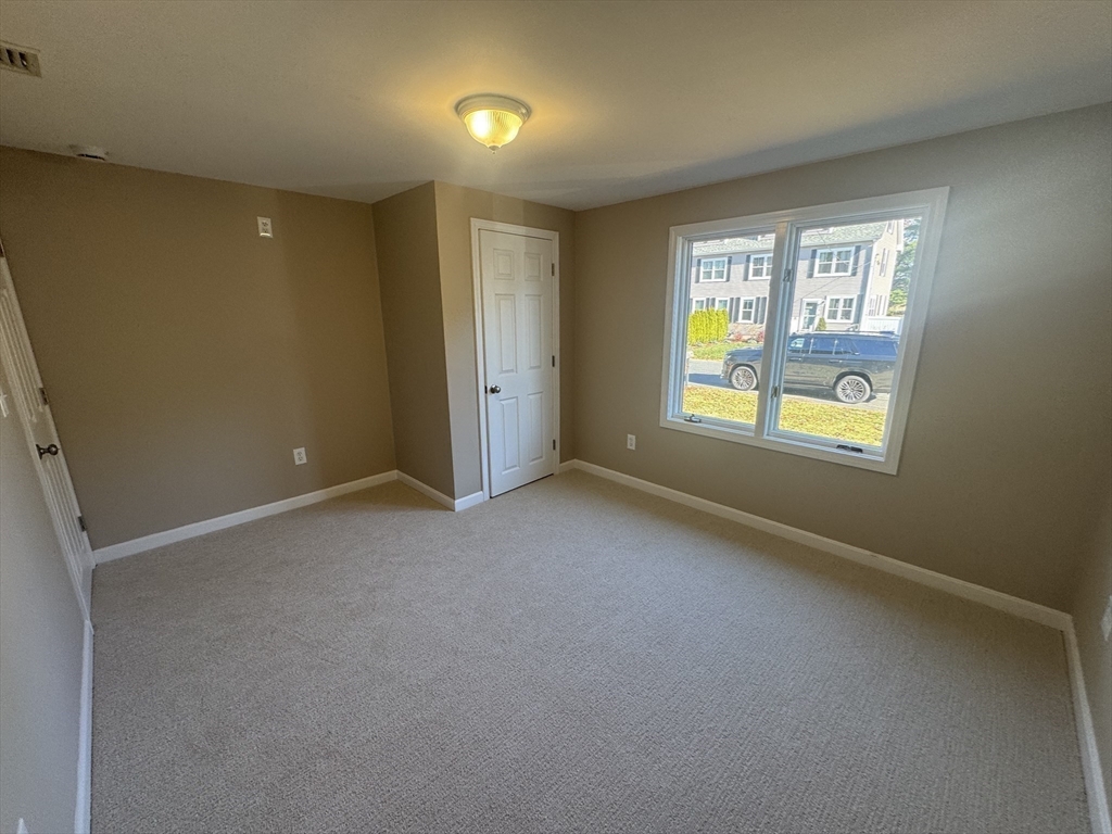 39 Neillian Street, Unit 39 Bedford, MA 01730 - Photo 11 of 29 a view of an empty room with a window