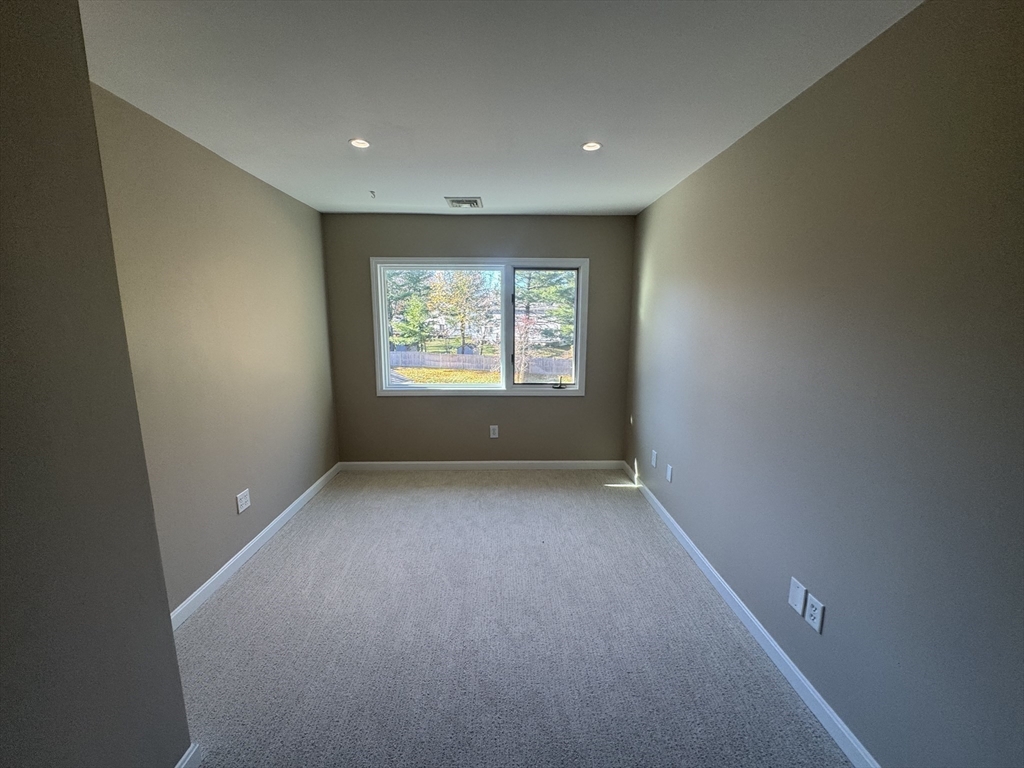 39 Neillian Street, Unit 39 Bedford, MA 01730 - Photo 12 of 29 a view of an empty room with a window