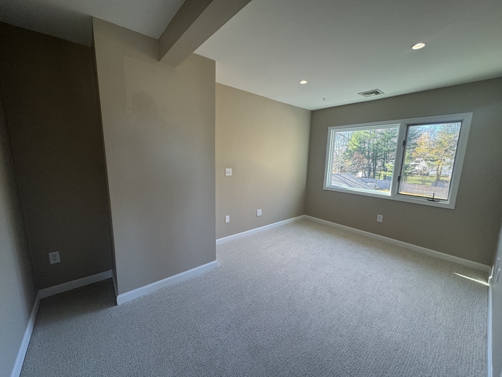 39 Neillian Street, Unit 39 Bedford, MA 01730 - Photo 15 of 29 a view of an empty room with windows
