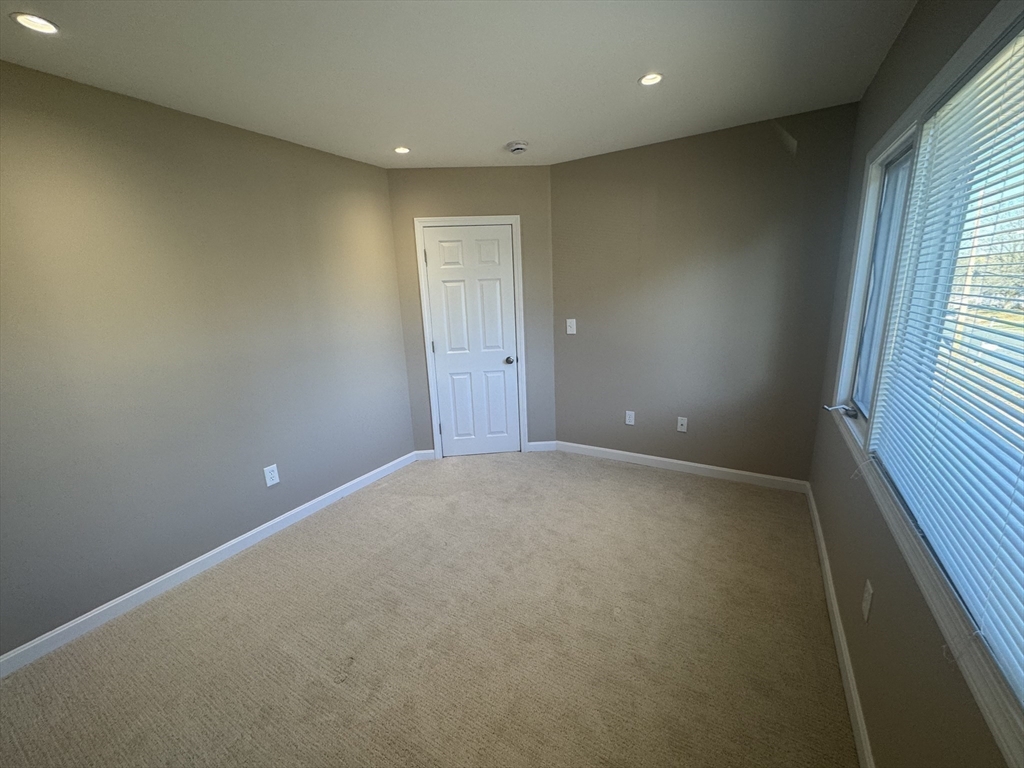 39 Neillian Street, Unit 39 Bedford, MA 01730 - Photo 19 of 29 an empty room with windows