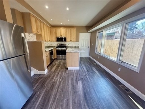 39 Neillian Street, Unit 39 Bedford, MA 01730 - Photo 2 of 29 a kitchen with a wooden floor and a refrigerator