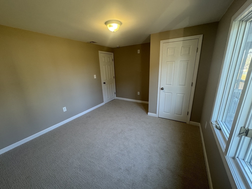 39 Neillian Street, Unit 39 Bedford, MA 01730 - Photo 22 of 29 an empty room with windows