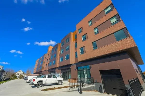 a front view of a building with parking