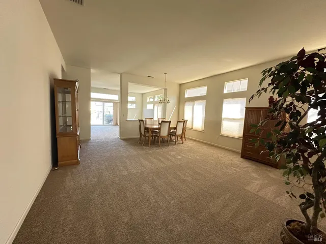 a view of a livingroom with furniture and floor to ceiling window