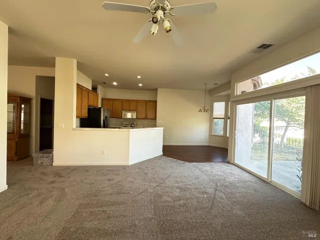 a view of a big room with windows and a kitchen