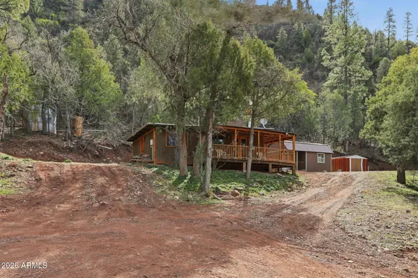a view of house with trees in the background