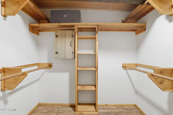 a view of walk in closet with empty racks