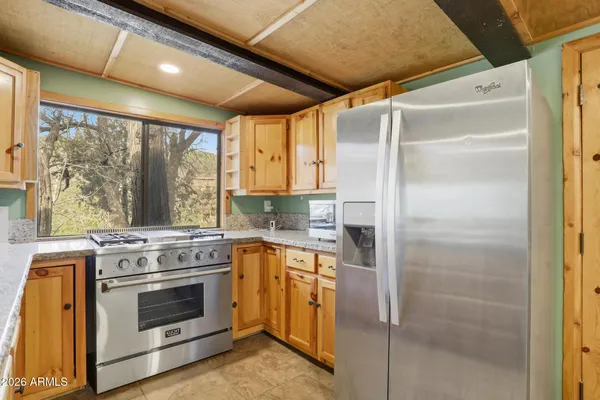 a kitchen with a stove sink and refrigerator