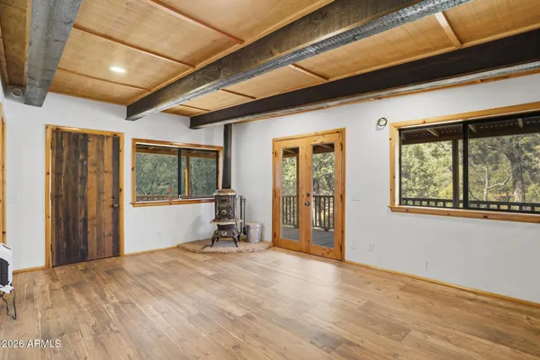 a view of a livingroom with wooden floor and a window