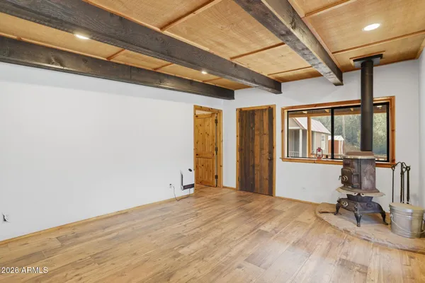 a view of a room with wooden floor and furniture