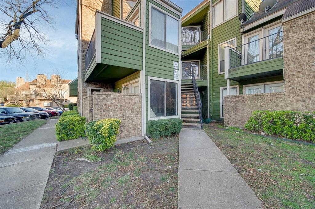 9815 Walnut Street, Unit 210 Dallas, TX 75243 - Photo 1 of 11 a view of a brick house with a yard and plants