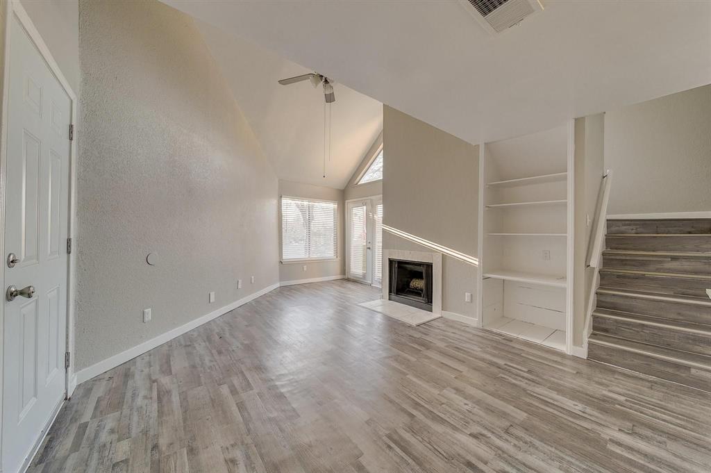 9815 Walnut Street, Unit 210 Dallas, TX 75243 - Photo 4 of 11 a view of a livingroom with wooden floor and staircase