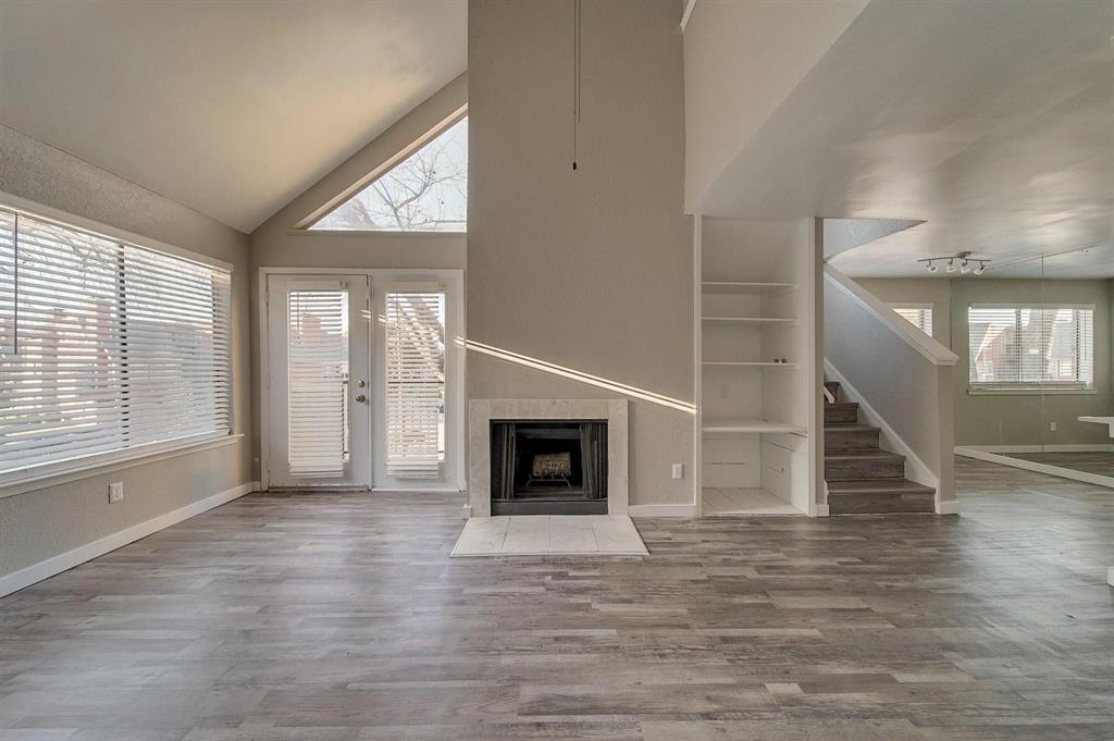 9815 Walnut Street, Unit 210 Dallas, TX 75243 - Photo 5 of 11 an empty room with wooden floor fireplace and windows