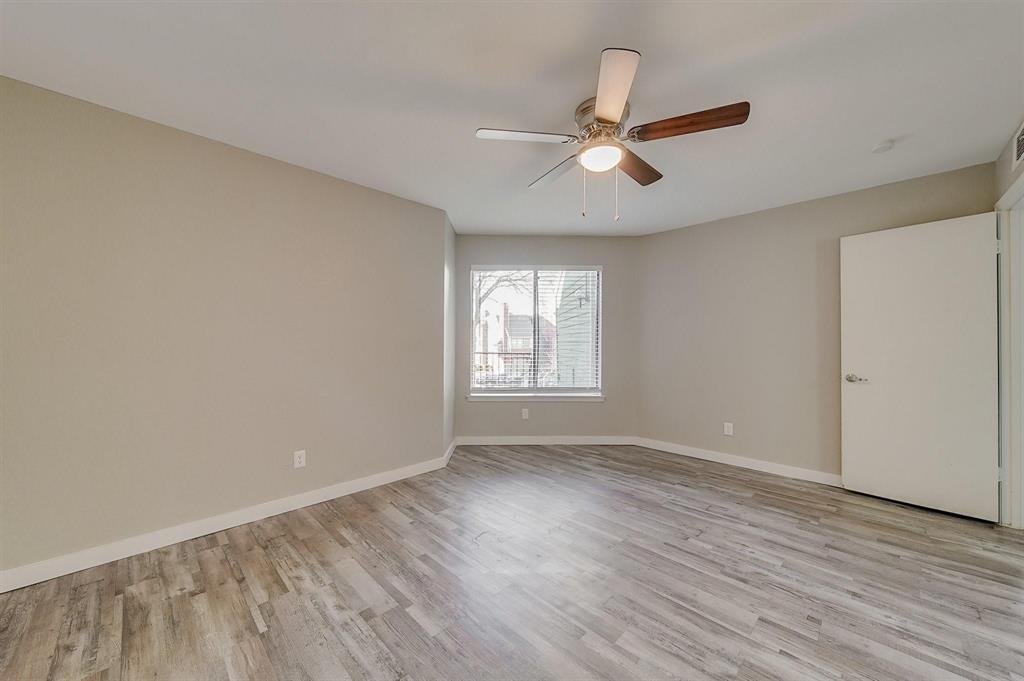 9815 Walnut Street, Unit 210 Dallas, TX 75243 - Photo 8 of 11 an empty room with wooden floor fan and windows