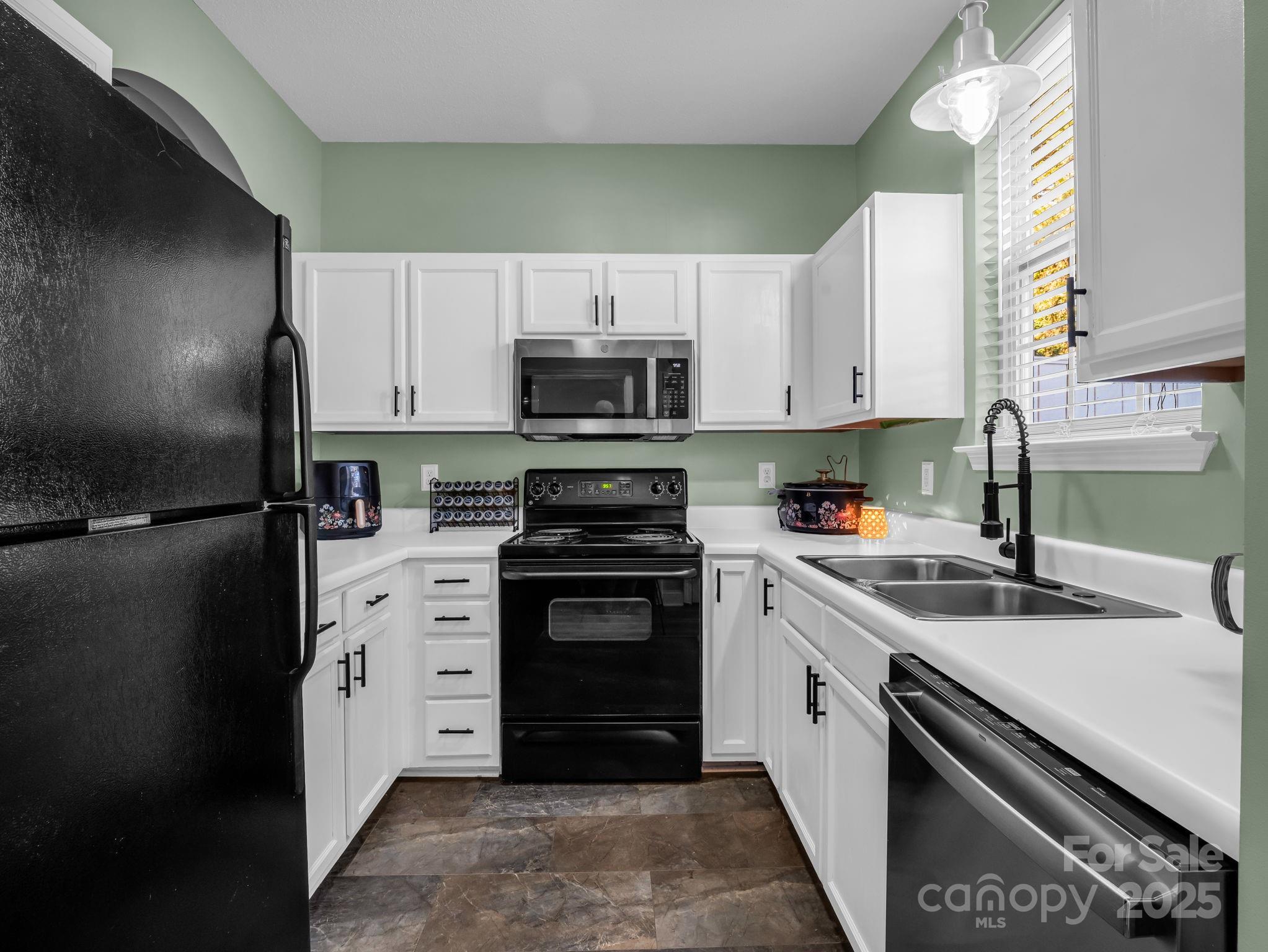 6103 Dane Drive Dallas, NC 28034 - Photo 11 of 29 a kitchen with a sink stove and refrigerator