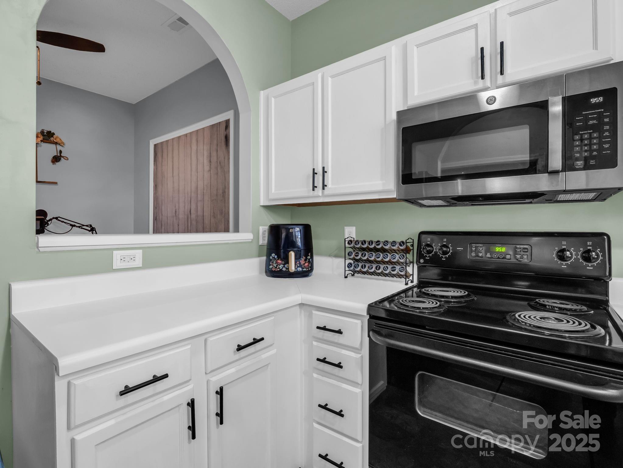 6103 Dane Drive Dallas, NC 28034 - Photo 13 of 29 a kitchen with stainless steel appliances a stove a microwave and cabinets