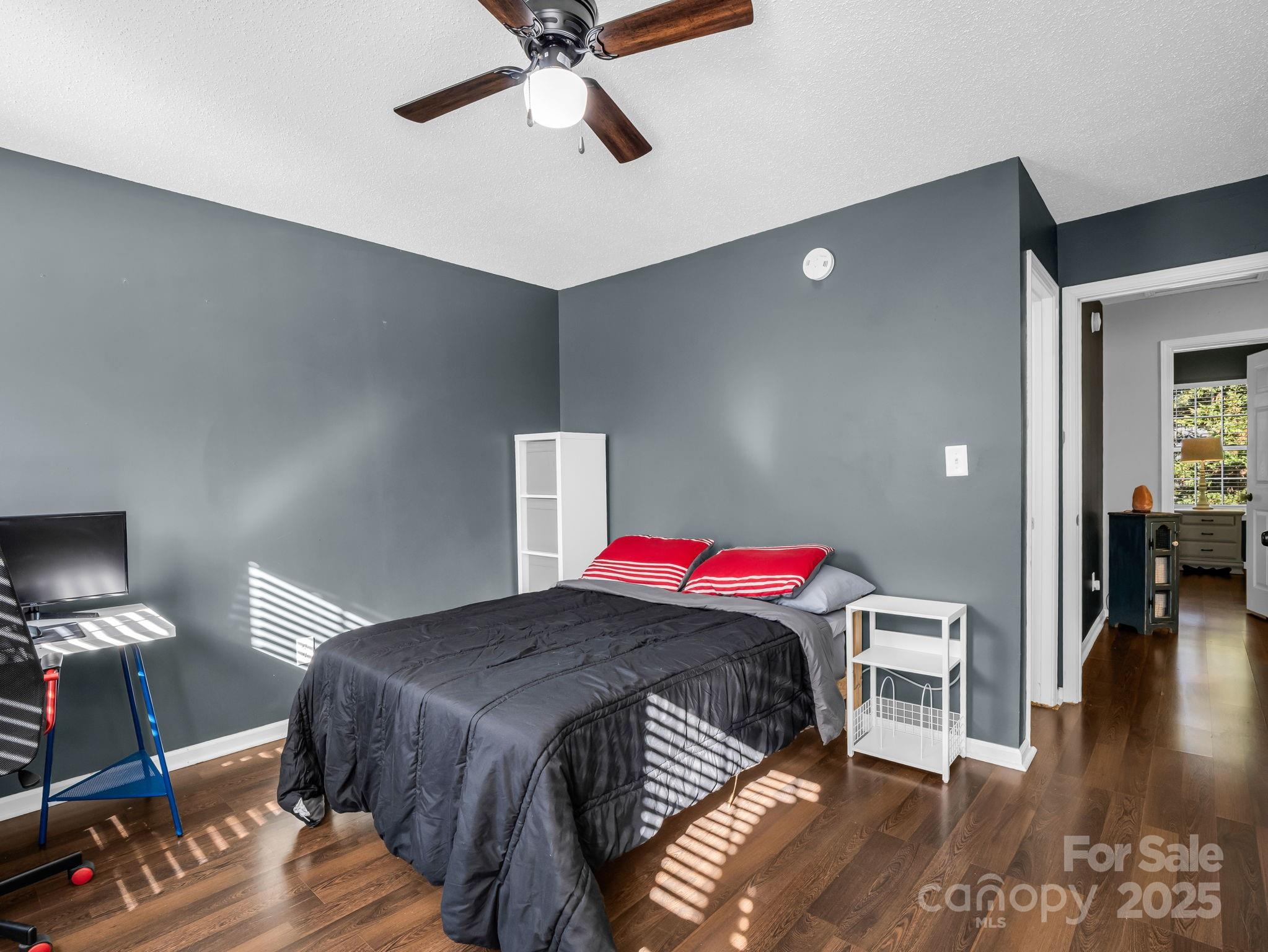 6103 Dane Drive Dallas, NC 28034 - Photo 20 of 29 a bedroom with a bed and wooden floor