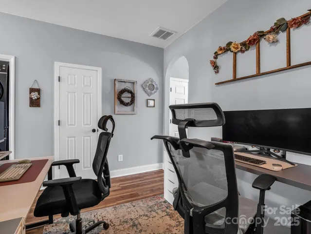 a view of a workspace with furniture and gym equipment