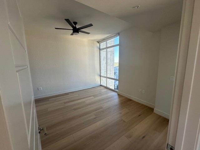 214 Barton Springs Road, Unit 922 Austin, TX 78704 - Photo 11 of 20 a view of a livingroom with wooden floor and a ceiling fan