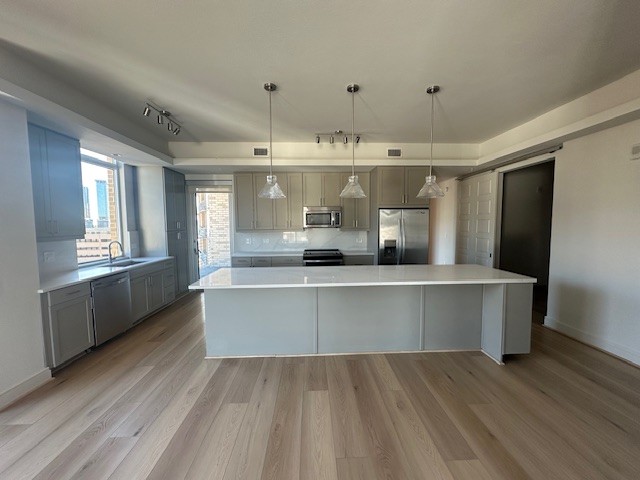 214 Barton Springs Road, Unit 922 Austin, TX 78704 - Photo 2 of 20 a large kitchen with stainless steel appliances a large counter top a stove and a refrigerator