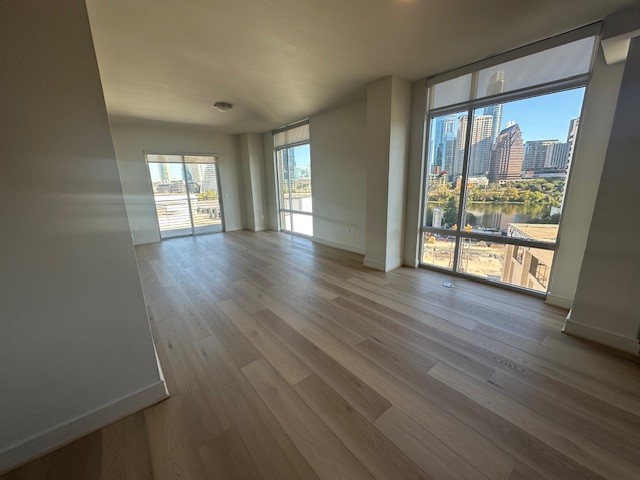 214 Barton Springs Road, Unit 922 Austin, TX 78704 - Photo 4 of 20 wooden floor in an empty room with a window
