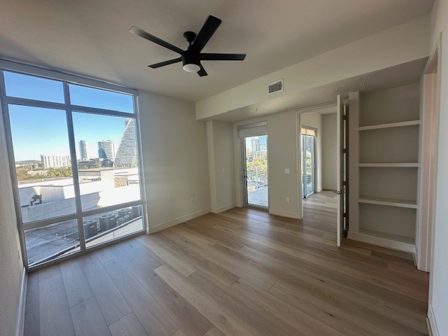 214 Barton Springs Road, Unit 922 Austin, TX 78704 - Photo 7 of 20 a view of empty room with wooden floor and fan