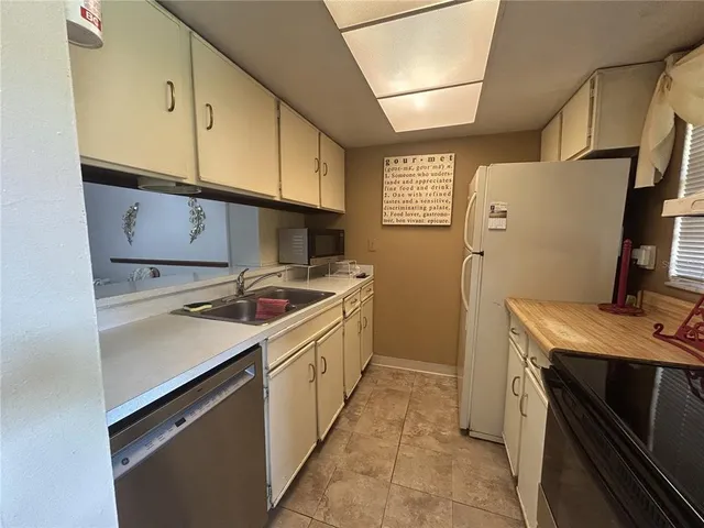 a kitchen with a sink cabinets and appliances