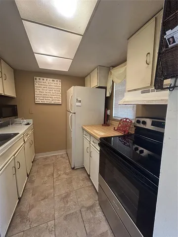 a kitchen with a stove and a refrigerator