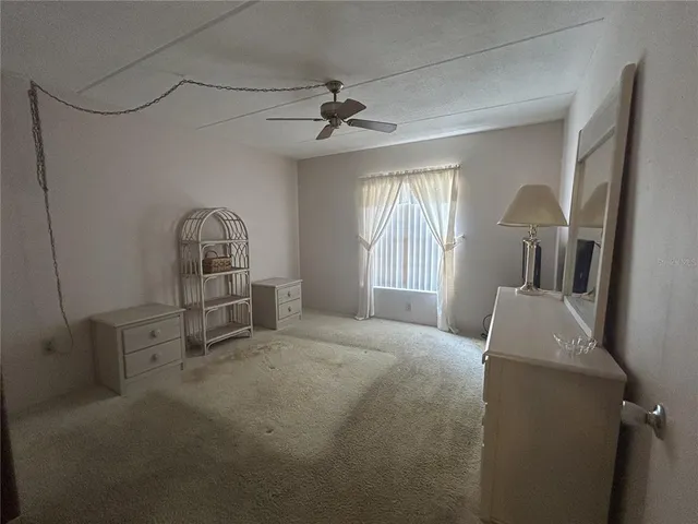 a view of livingroom with furniture and chandelier fan