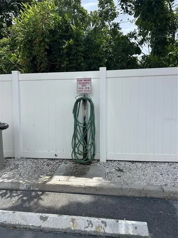 a couple of palm trees sitting in a yard with swimming pool
