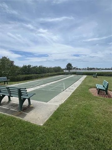 a swimming pool with outdoor seating and wooden fence