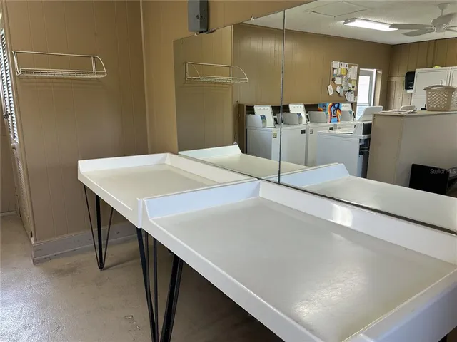 a room with pool table and windows