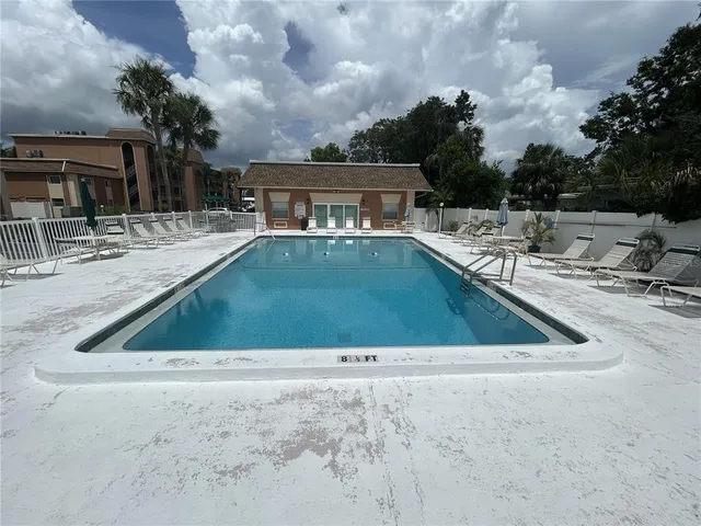 a front view of a house with a yard and lake view