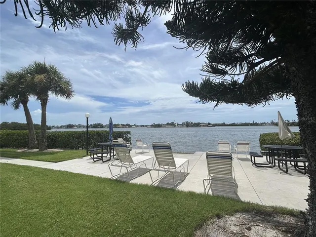 a view of a lake with a table and chairs