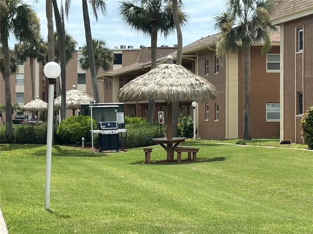 a view of a house with backyard porch and sitting area