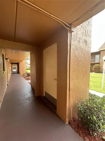 a view of a hallway with wooden shelves