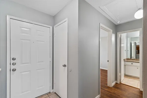 a view of empty room with wooden floor