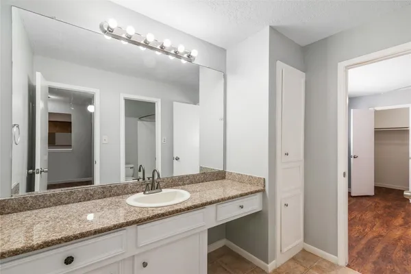 a bathroom with double vanity and a mirror
