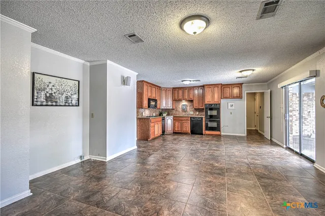 a view of a kitchen with furniture and a window