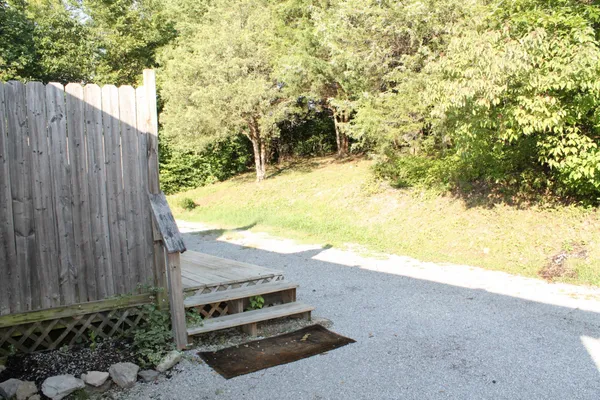 a view of a yard with wooden fence