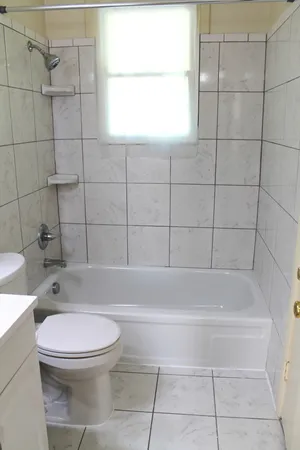 a bathroom with a toilet and bathtub