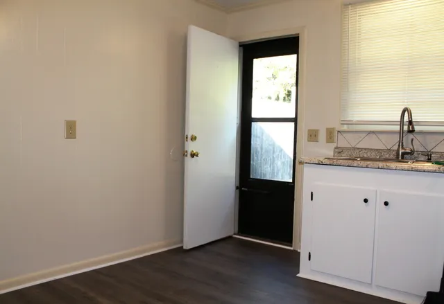 a view of front door with wooden floor